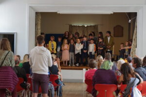 a group of children perform on stage